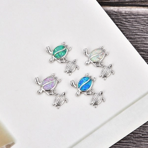 Polished silver turtle pendant with opal shell inlay in green, white, purple, and blue