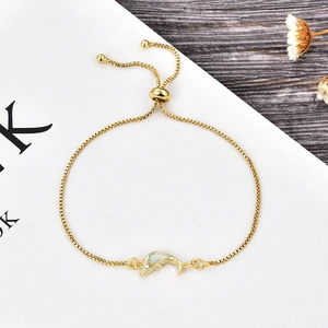 Detail of adjustable dolphin bracelet with gold box chain and white opal stone inlay