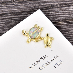 Detailed view of turtle pendant with rainbow opal inlay and gold plating finish
