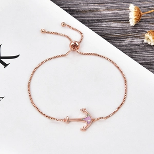 Detail of rose gold anchor bracelet with purple opal inlay and adjustable slider chain