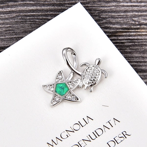 Detail of silver turtle star pendant with green opal and white cubic zirconia stones