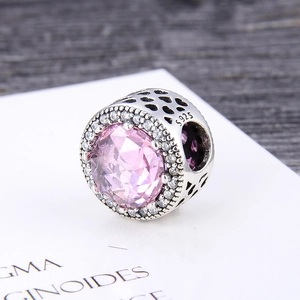 Detailed close-up of S925 silver charm with pink zirconia and hollow heart patterns