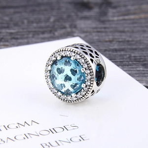 Detail of S925 sterling silver bead charm featuring blue zircon and hollow heart patterns