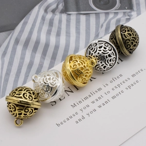 Detail showing colorful hollow spiral pattern metal bell pendants for DIY jewelry crafting