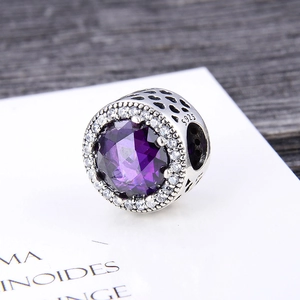Close-up of S925 silver charm with purple stone and hollow heart-shaped side details