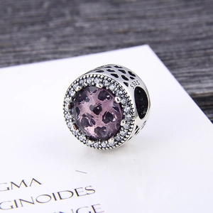 Detailed macro of S925 silver charm with purple heart crystal and pavé zircon stones