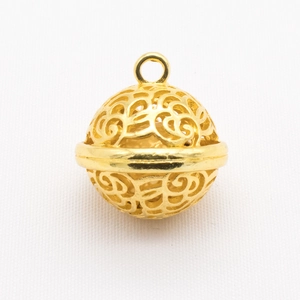 Close-up of golden hollow filigree ball pendant with intricate floral patterns for DIY jewelry