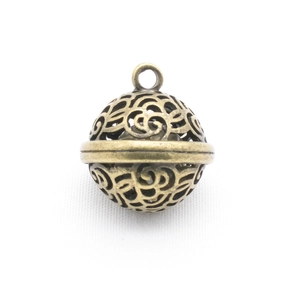 Detail of vintage bronze hollow bell pendant with intricate Chinese filigree pattern