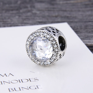 Macro view of S925 silver charm bead featuring a large zircon and hollow heart patterns