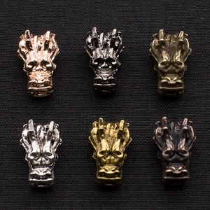 Detailed view of alloy dragon head charms in six metallic finishes for DIY jewelry