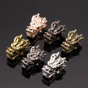 Macro view of detailed dragon head alloy charms in six different electroplated metallic colors