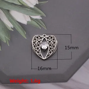 Macro shot of silver heart pendant with hollow pattern and zircon inlay measurements