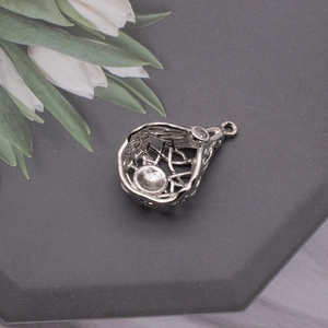 Detail of silver heart-shaped bird nest pendant with zircon for DIY jewelry making