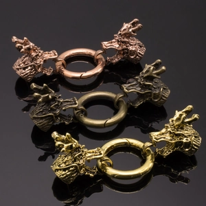 Macro shot of vintage dragon head jewelry clasps in gold, bronze and rose gold finishes