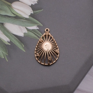 Detailed view of rose gold birdcage pendant with hollow radial lines on stone surface