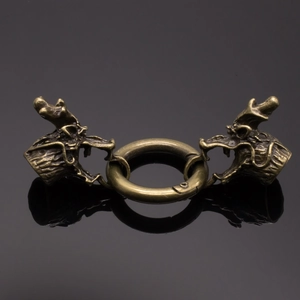 Macro shot of vintage brass dragon head clasp with spring ring for DIY crafts