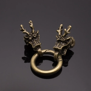 Detailed macro view of vintage brass dragon head clasp with intricate handmade textures