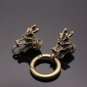 Detailed macro view of vintage bronze dragon head clasps for DIY jewelry making