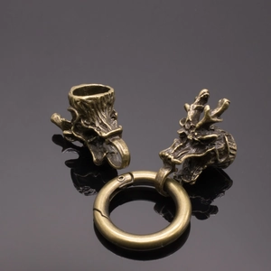 Detail of vintage brass dragon head beads and spring ring clasp for DIY jewelry