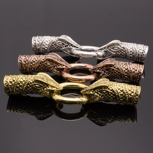 Detailed view of dragon head metal jewelry clasps in gold, silver, and bronze finishes