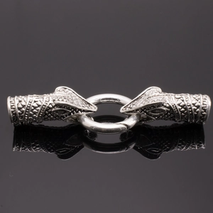 Detailed macro view of vintage silver snake head connectors and spring ring jewelry clasp