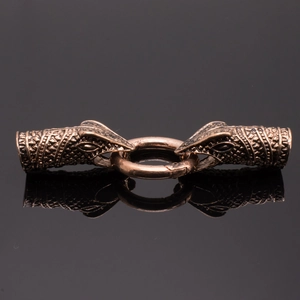 Close-up of vintage dragon head jewelry clasps with detailed scales and bronze finish