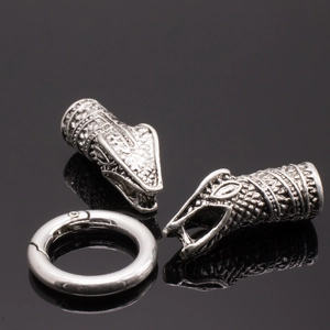 Detail of silver snake head beads and polished spring ring clasp for DIY jewelry