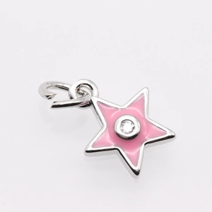 Macro shot of pink enamel star pendant with zircon center and silver plating detail