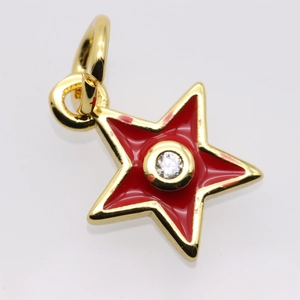 Detailed view of a gold-plated star pendant with red enamel and central zircon stone