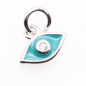 Macro view of a silver evil eye pendant with blue enamel and sparkling zircon stone
