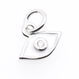 Macro detail of silver evil eye pendant with white enamel and sparkling zircon stone