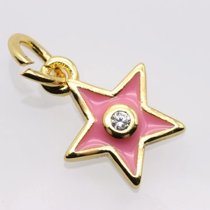 Close-up of gold star pendant featuring pink enamel filling and a center zircon stone