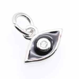 Macro detail of silver Evil Eye pendant with black enamel and clear sparkling zircon