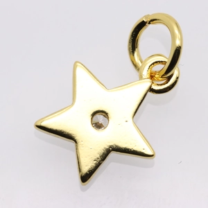Macro shot of gold plated star pendant with central round cut zircon stone detail