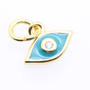 Macro shot of evil eye pendant featuring blue enamel and clear cubic zirconia stones