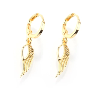 Detailed macro view of golden wing charms with intricate textures on hoop earrings