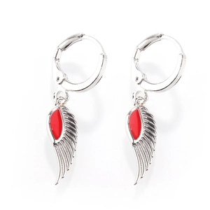 Detail of silver hoop earrings with red enamel angel wing pendants on white background