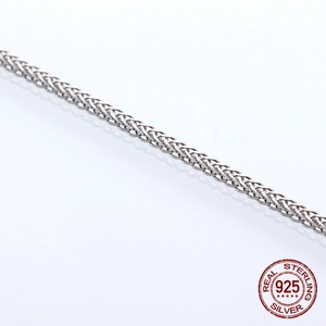 Detailed close-up of real S925 sterling silver wheat chain with polished metal texture