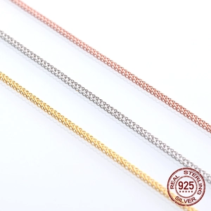 Macro view of S925 sterling silver spiga chain textures in gold, silver and rose gold