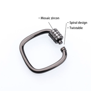 Macro shot of gun-black square metal jewelry clasp with spiral screw and mosaic zircon