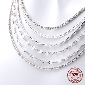 Close-up of various S925 sterling silver chain styles including box and wave patterns