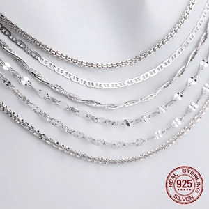 Detailed view of various S925 sterling silver chain styles like box and snake chains