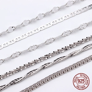 Detail of various S925 sterling silver chain styles including box and snake link textures