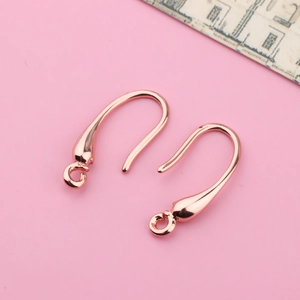 Detailed macro view of rose gold plated DIY earring hooks with polished smooth surface