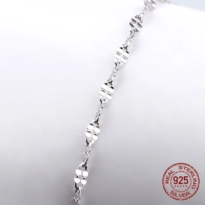 Close-up of S925 sterling silver chain with textured flat heart links in metallic finish