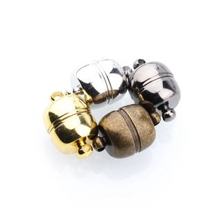 Dettaglio macro di chiusure magnetiche sferiche in oro argento canna di fucile e bronzo