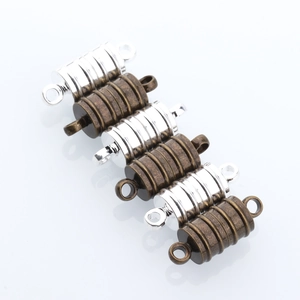 Detail view of cylindrical magnetic jewelry clasps in silver and antique bronze finish