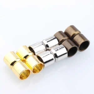 Detail view of cylindrical magnetic jewelry clasps in gold, silver, and bronze plating