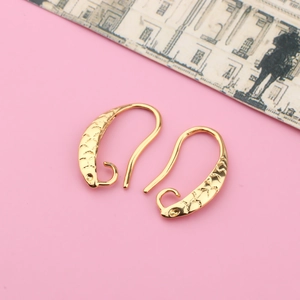 Detailed view of golden fish-scale texture DIY earring hooks with round hanging loops