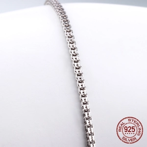 Detailed macro shot of 925 sterling silver box chain necklace with polished finish